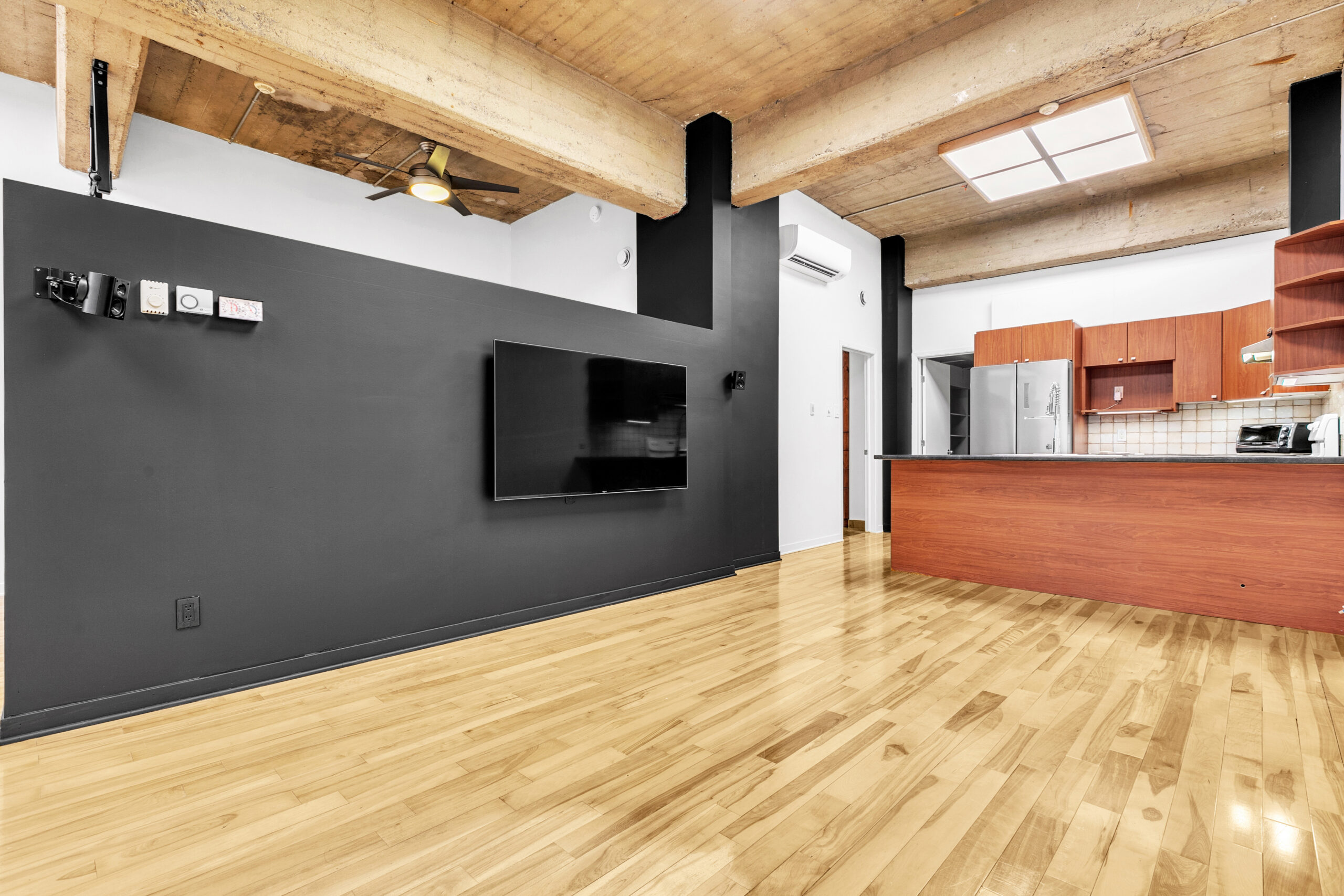 Intérieur de style loft d'un condo à Verdun — plafond de béton et plancher de bois